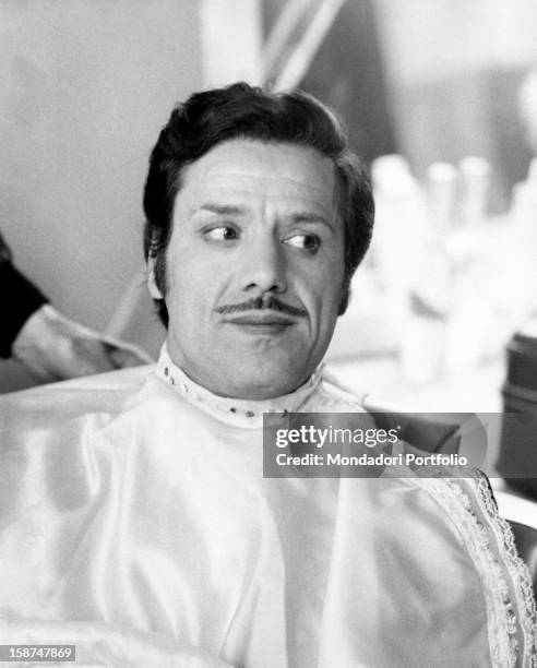 Italian actor and singer Franco Franchi at the make-up on the set of the film Principe coronato cercasi per ricca ereditiera. Rome, 1970