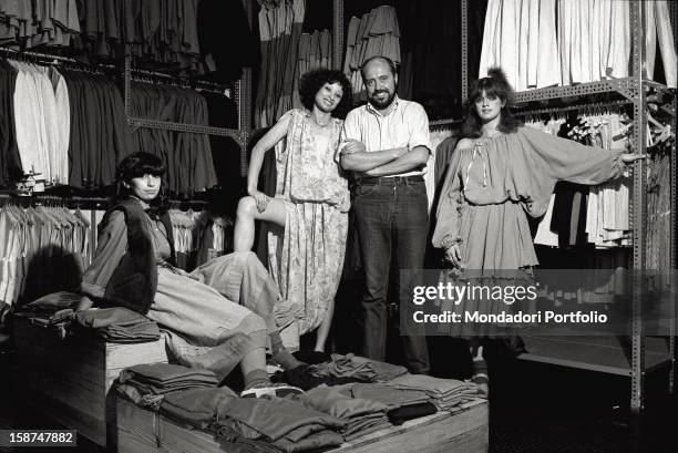 Italian fashion designer and entrepreneur Elio Fiorucci posing with the shop assistants of the shop where the retailers stock up. Milan, 1974