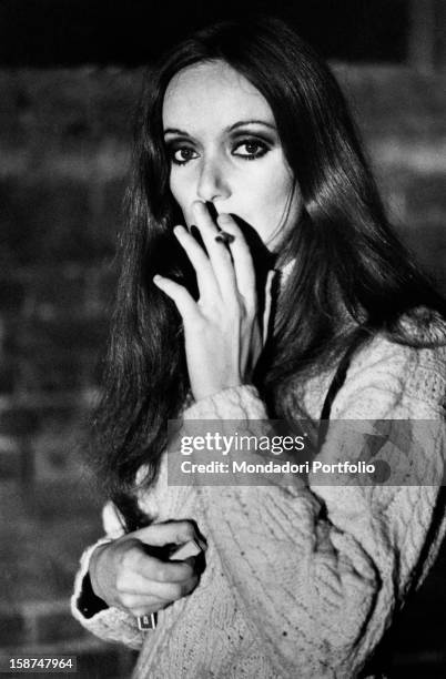 Italian actress Delia Boccardo smoking on the set of Come un uragano. Clare, 1971