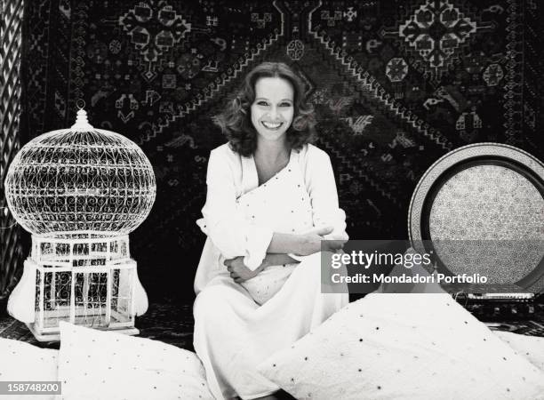 Portrait of the Italian actress Laura Antonelli sitting on the terrace of her house. Rome, 1979