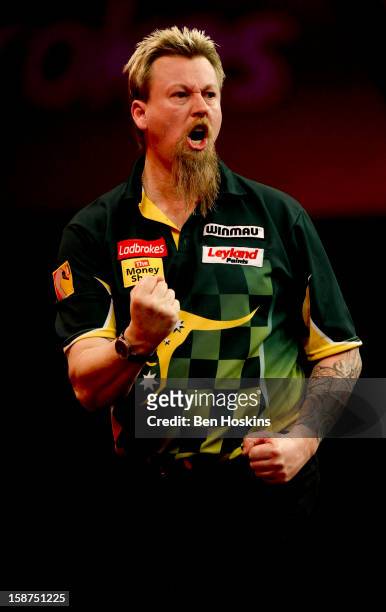 Simon Whitlock of Australia celebrates during his third round match against Dave Chisnall on day eleven of the 2013 Ladbrokes.com World Darts...