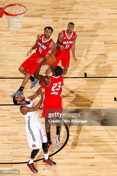 Chamberlain Oguchi of the Maine Red Claws shoots over Jai Lucas of the Idaho Stampede during the NBA D-League game on December 26, 2012 at...