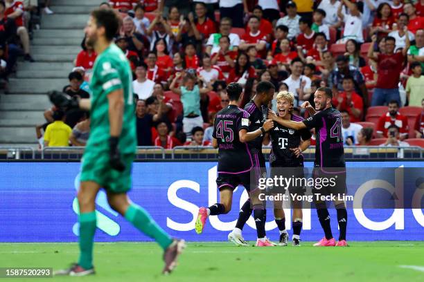 Frans Kratzig of Bayern Munich celebrates with teammates after scoring their fourth goal against Liverpool during the second half of the pre-season...