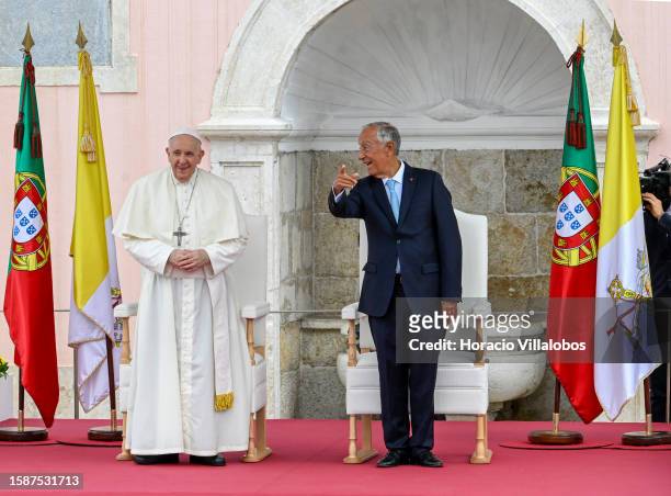 Pope Francis and Portuguese President Marcelo Rebelo de Sousa chat standing side by side outside Belem Presidential Palace at beginning of the State...