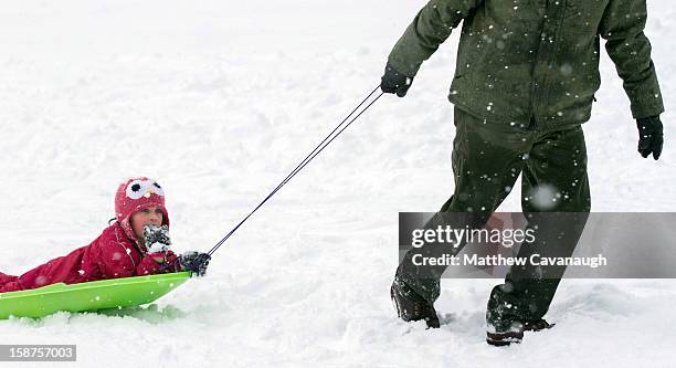 Six-year-old Amaya Eddy of Trenton, ME is pulled along on a sled by her father on December 27, 2012 in Greenfield, Massachusetts. A serious winter...