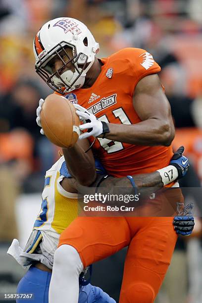 Wide receiver Chris Gallon of the Bowling Green Falcons drops a pass while being hit by linebacker Doug Parrish of the San Jose State Spartans during...