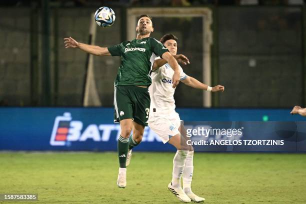 Panathinaikos' Slovenian forward Andraz Sporar fights for the ball with Marseille's Argentine defender Leonardo Balerdi during the UEFA Champions...