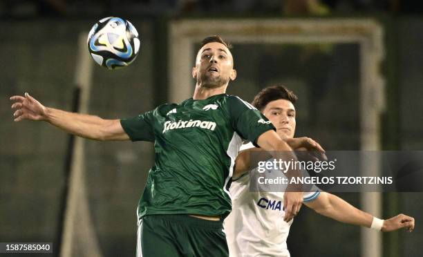 Panathinaikos' Slovenian forward Andraz Sporar fights for the ball with Marseille's Argentine defender Leonardo Balerdi during the UEFA Champions...