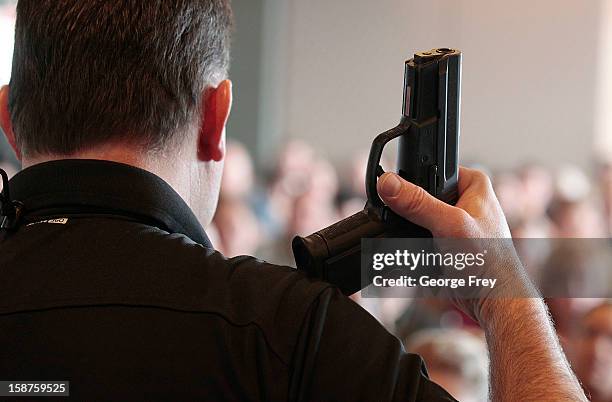 Firearm instructor Clark Aposhian holds a handgun up as he teaches a concealed-weapons training class to 200 Utah teachers on December 27, 2012 in...