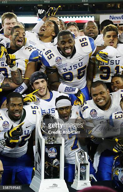 Members of the San Jose State Spartans pose with the trophy after defeating the Bowling Green Falcons 29-20 to win the Military Bowl at RFK Stadium...
