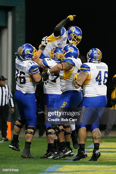 Running back De'Leon Eskridge of the San Jose State Spartans is lifted into the air by teammates after scoring a fourth quarter touchdown against the...