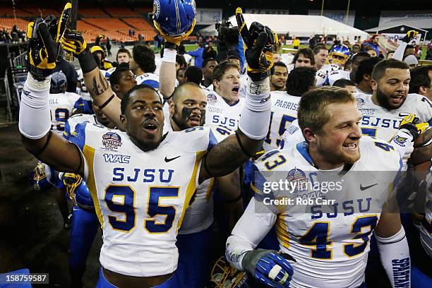 Sean Bacon and Travis Johnson of the San Jose State Spartans celebrate after defeating the Bowling Green Falcons 29-20 to win the Military Bowl at...