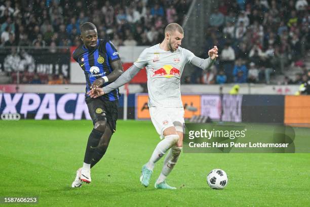 Marcus Thuram of FC Internationale and Strahinja Pavlovic of Salzburg compete for the ball during the Pre-season Friendly match between FC Red Bull...