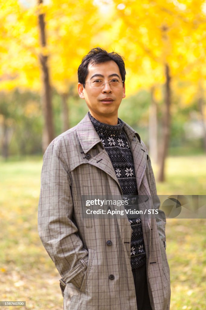 Asian man in autumn forest