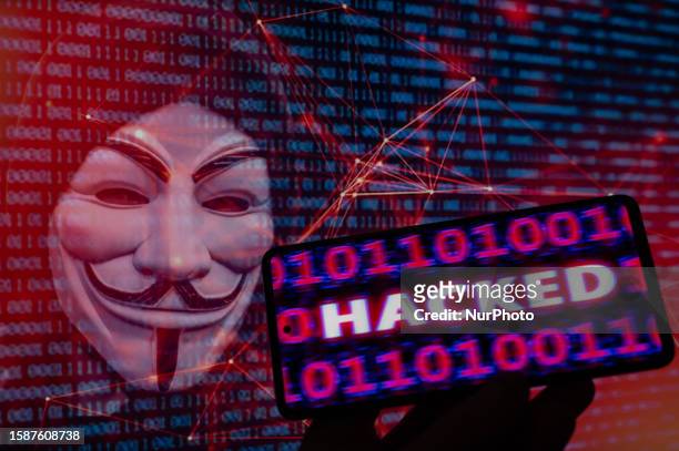 Hacked displayed on a mobile with binary code with in the background Anonymous mask. On 9 August 2023 in Brussels, Belgium. Jonathan Raa / Nurphoto
