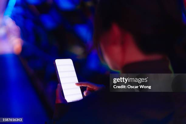 close-up of young asian business woman using smartphone against futuristic background - instagram mockup stock-fotos und bilder