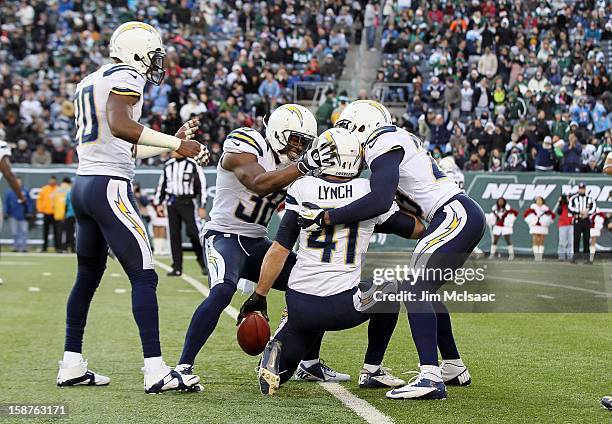 Corey Lynch of the San Diego Chargers celebrates his interception against the New York Jets with teammates Marcus Gilchrist and Quentin Jammer at...