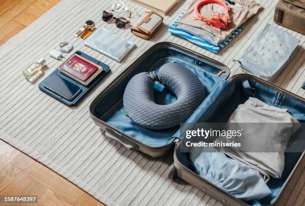 close up shot of an open suitcase with stuff ready for a trip - travesseiro imagens e fotografias de stock