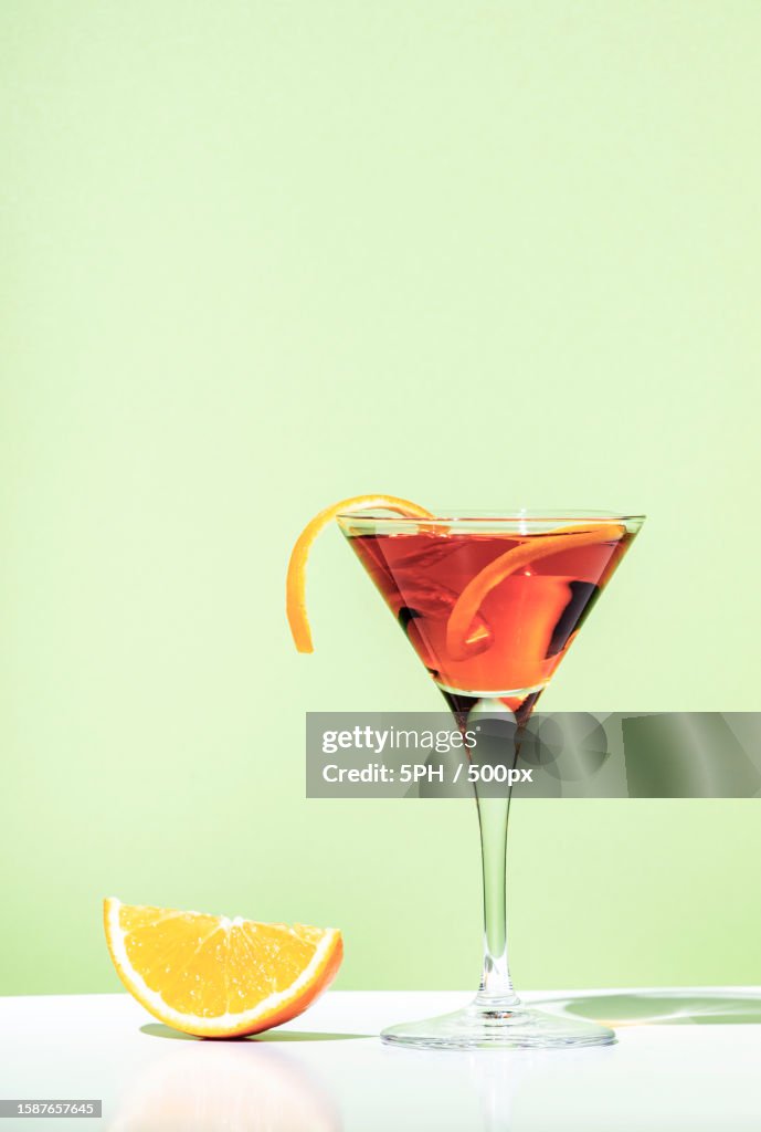 Close-up of drink in glass against yellow background