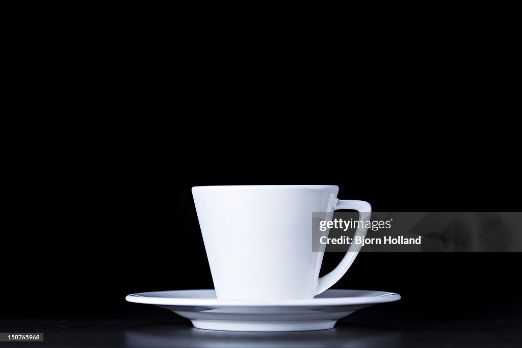 White coffee cup on black background