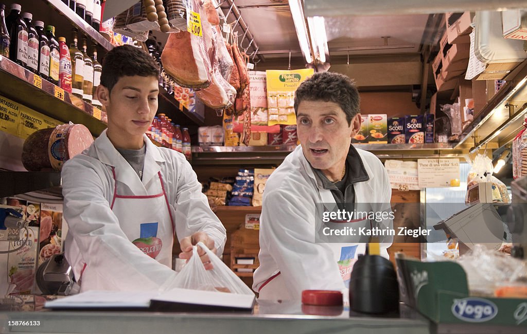 Father and son working at delicatessen together