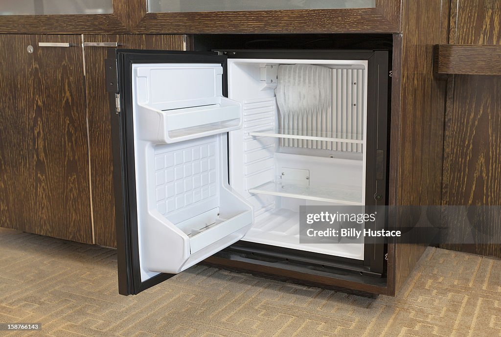 Empty mini fridge in a hotel room