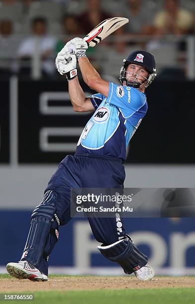 Phil Mustard of Auckland hits a six during the HRV Cup Twenty20 match between the Auckland Aces and Wellington Firebirds at Eden Park on December 28,...