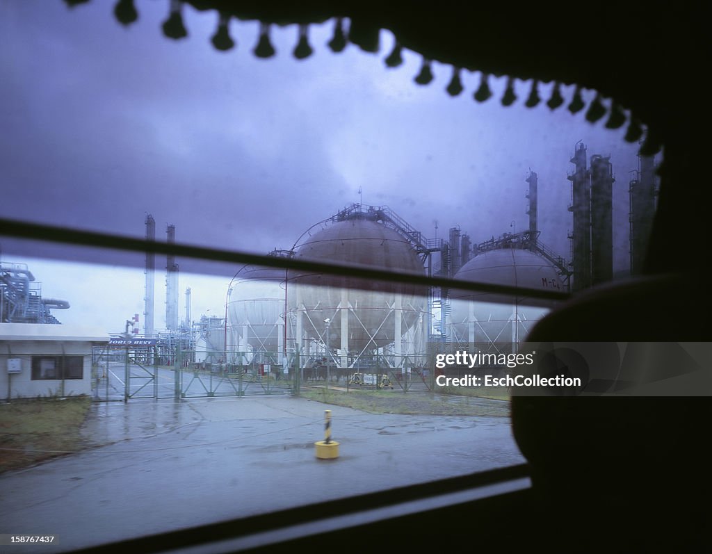 Refinery on a dreary day, from window of a bus
