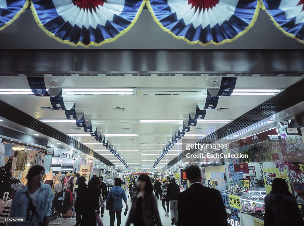 People shopping at underground arcade in Seoul