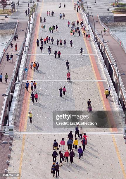 people crossing pedestrian bridge on a sunny day - jeollanam do stock pictures, royalty-free photos & images