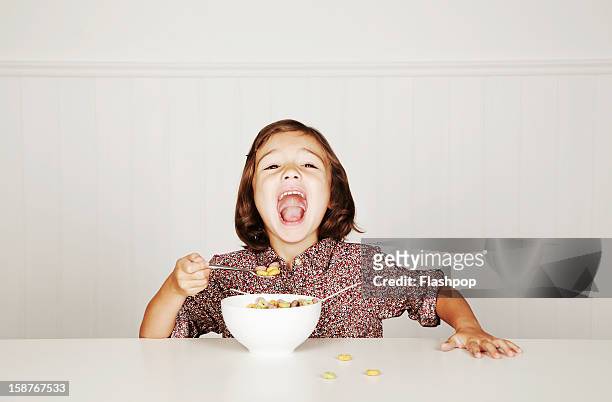 portrait of girl with cereal - cereals fotografías e imágenes de stock