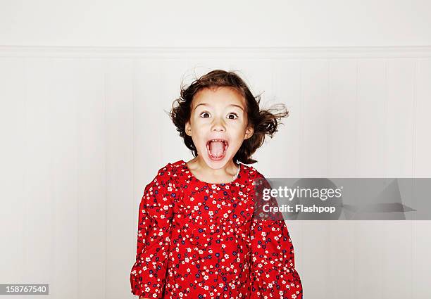 portrait of girl pulling funny faces - kids excited stockfoto's en -beelden