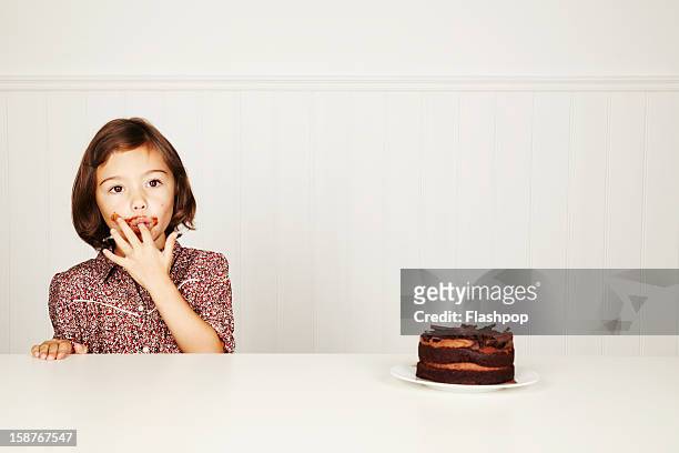 portrait of girl with chocolate cake - finger in mouth fotografías e imágenes de stock