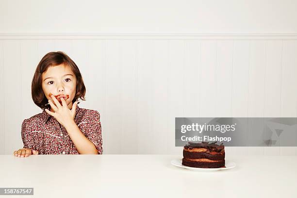 portrait of girl with chocolate cake - 指をくわえる ストックフォトと画像