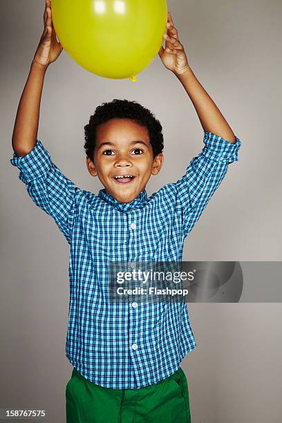 portrait of boy with balloon - child balloon studio photos et images de collection