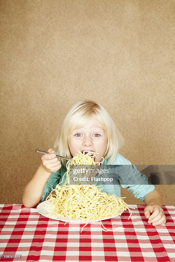 Portrait of girl eating spaghetti