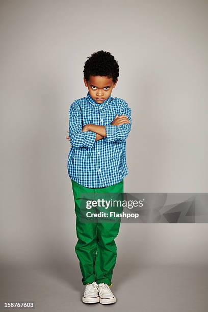 portrait of boy sulking - kids standing crossed arms stock pictures, royalty-free photos & images