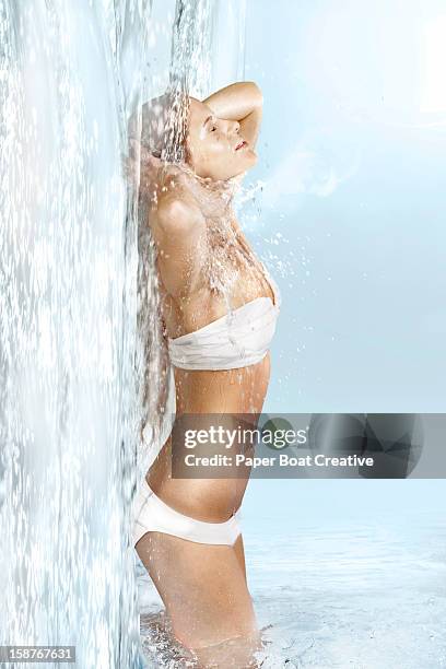 lady bathing by the side of a waterfall - woman bath tub wet hair stock pictures, royalty-free photos & images