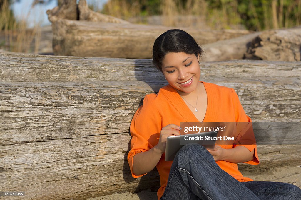 Student at beach with tablet