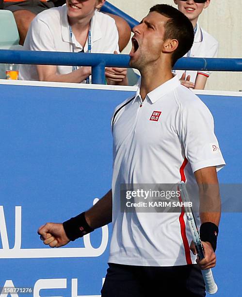 World number one tennis player, Serbia's Novak Djokovic, celebrates after winning 6-0, 6-3, over Spain's David Ferrer during their Mubadala World...