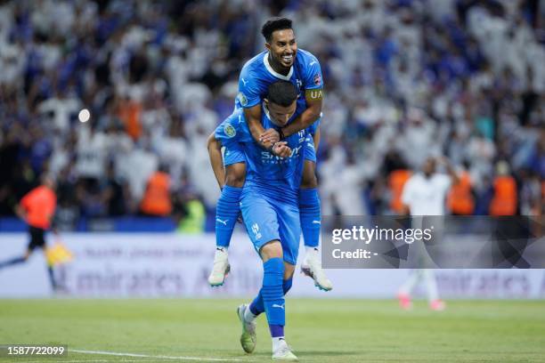 Saudi Arabia's Al-Hilal players Abdullah al-Hamdan and Salem al-Dawsari celebrate after their team beat Al-Shabab during the 2023 Arab Club Champions...