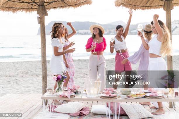women raising arms and dancing on a beach - palma beach stock pictures, royalty-free photos & images
