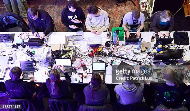 Participants work at their laptops at the annual Chaos Computer Club computer hackers' congress, called 29C3, on December 28, 2012 in Hamburg,...