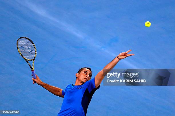 Spain's Nicolas Almagro serves to Serbia's Janko Tipsarevic during their Mubadala World Tennis Championship match in the Emirati capital Abu Dhabi on...