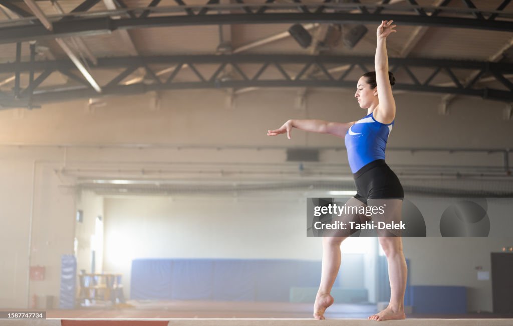 Female Gymnast On Balance Beam