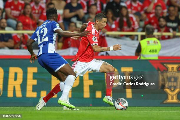 Angel Di Maria of SL Benfica tries to escape Zaidu Sanusi of FC Porto (L9 during the match between SL Benfica and FC Porto for the Supertaca de...