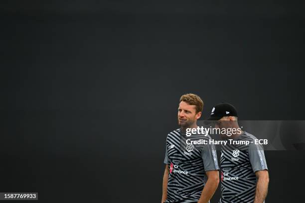 Jos Buttler of Manchester Originals speaks to Manchester Originals Head Coach Simon Katich during The Hundred match between Welsh Fire Men and...