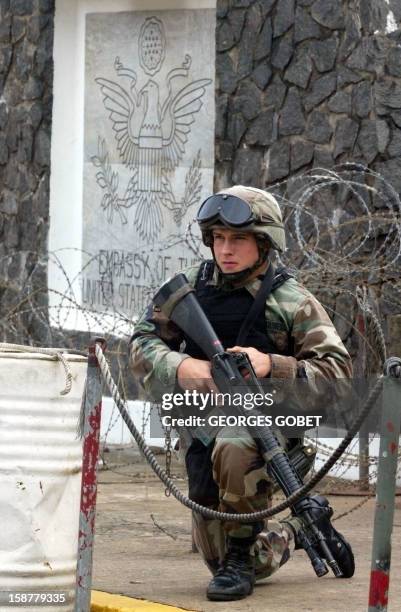 An American Marine assures security at the US Embassy in Monrovia 27 July 2003. Fighting erupted during the late afternoon near the embassy. The...