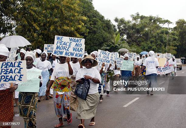 Liberian woman stage 28 August 2003 a protest march in front of the ECOMIL headquarters in Monrovia. The Liberian Women Mass Actions for Peace...