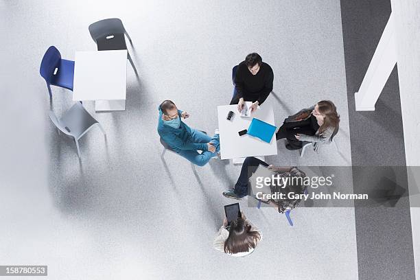start up business planning meeting in new office - overhead business shadows stock pictures, royalty-free photos & images